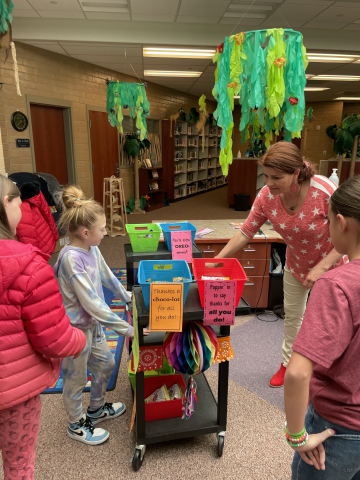 Ms. Stacey, our librarian, choosing a treat from the Kindness Cart.