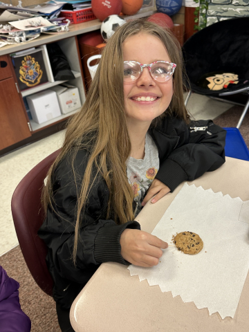 Student "mining" their chocolate chips out of their cookie.