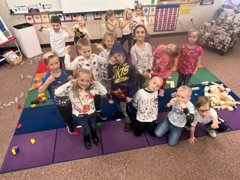 A kindergarten class on the rug on the 100th day of school.