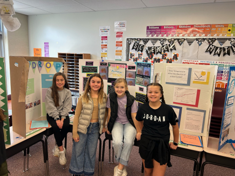 Students in front of their science fair projects.