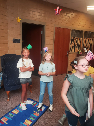 Students wearing paper hats