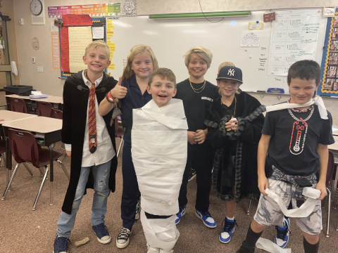Fourth graders playing mummy wrap game.