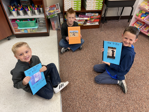 Students holding their "How To" Books.