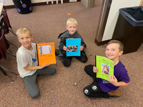 Students holding their "How To" Books.