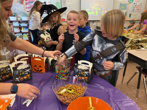 Students making Halloween treats.