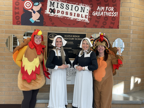 Office staff dressed as turkeys and pilgrims.