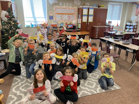 Students showing their dragons they made for Chinese New Year.