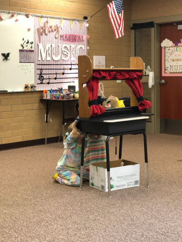 Student doing a puppet show.