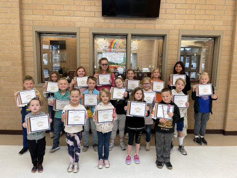 April students of the month with their certificates.
