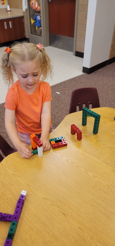 Making obstacle courses to practice positional words.