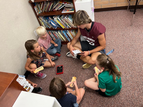 Maple Mountain High School football player playing games with second graders.