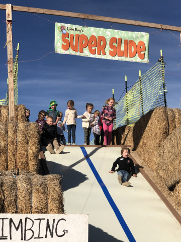 Kindergarteners going down the slide.