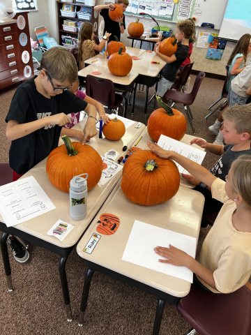 Students working on a pumpkin project.