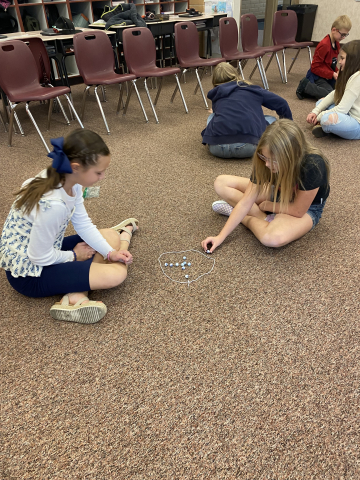 Students playing marbles.