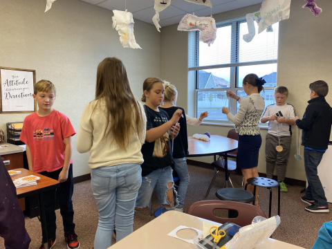 Students playing with whirligigs.