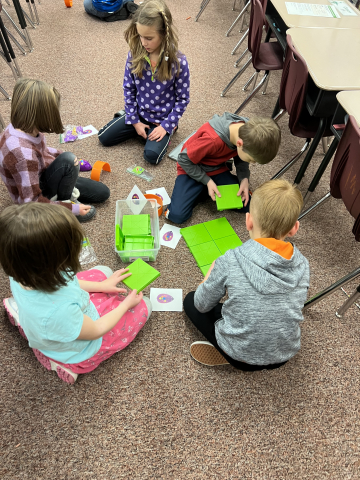 2nd graders using Code and Go Robots.