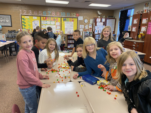 Students constructing a Christmas Tree with just toothpicks and Dots candy.