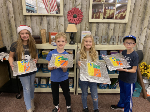 Fourth grade students holding their salt dough maps of Utah.