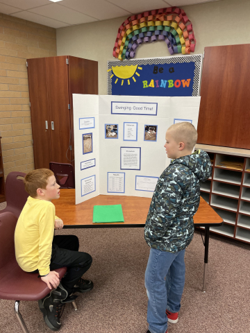 Students presenting to other students about their science fair projects.