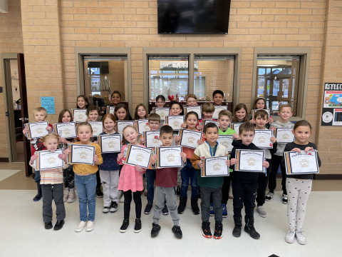 Students of the month holding their certificates.
