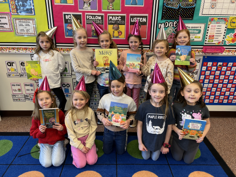 First graders holding Mercy Watkins books.