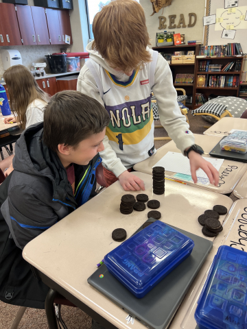 Fifth graders using Oreos to learn about data analysis.