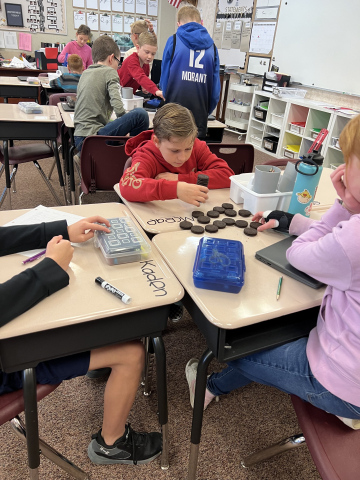 Fifth graders using Oreos to learn about data analysis.