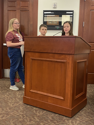 Student presenting at board meeting.