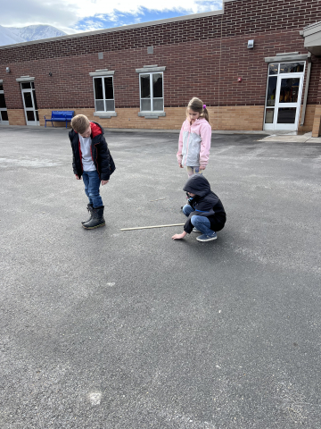 Students measuring how far they jumped.
