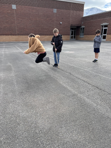 Students measuring how far they jumped.