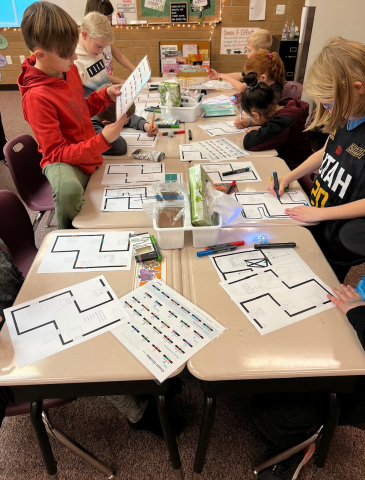 Students using Ozobots to review multiplication facts.