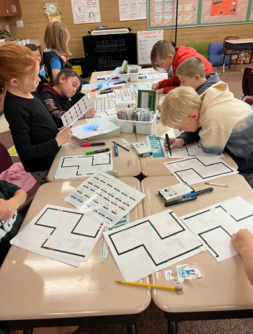 Students using Ozobots to review multiplication facts.