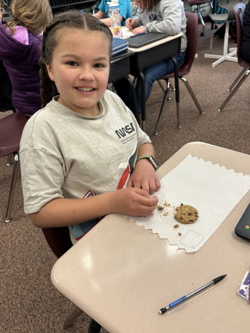 Student "mining" their chocolate chips out of their cookie.