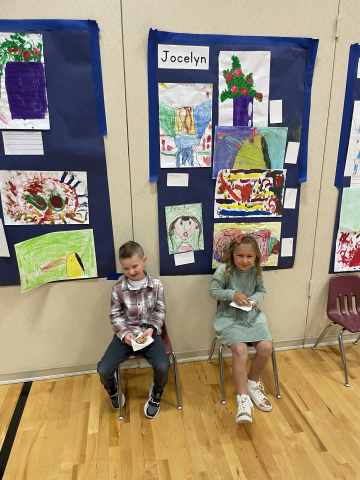Students in front of their artwork.