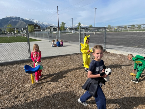 Students playing with their stuffed animals on the playground.
