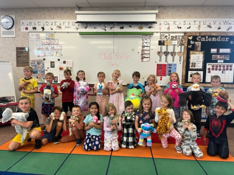 Class picture with students holding their stuffed animals.