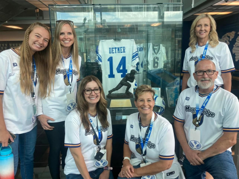 The fourth grade team in front of Ty Detmer's display.