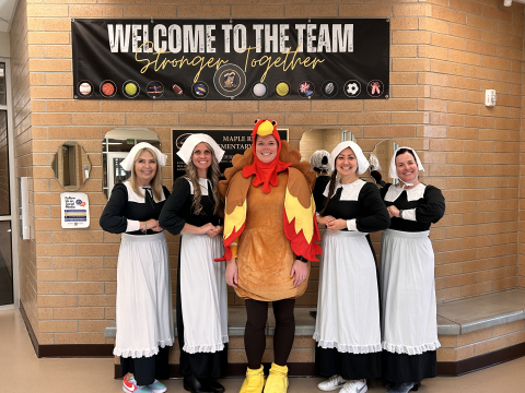 The office staff dressed as a turkey and pilgrims.
