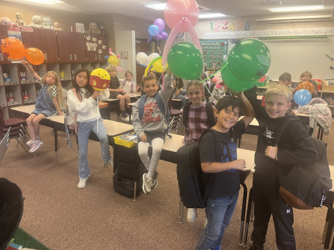 Students holding their balloon floats.
