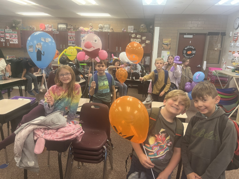 Students holding their balloon floats.