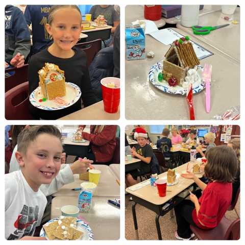 Students showing their gingerbread houses.