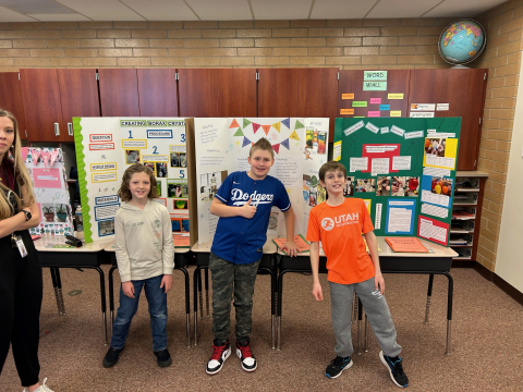 Students in front of their science fair projects.