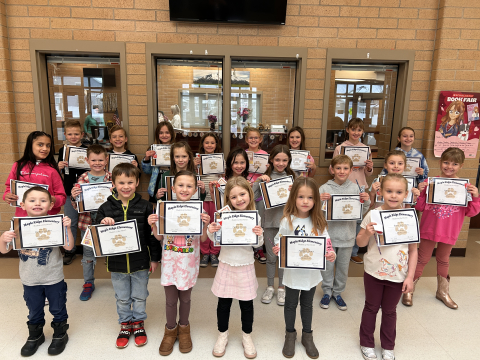Students holding their Student of the Month certificates.