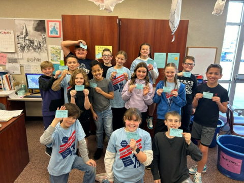 5th graders holding their "Prize inside" cards.