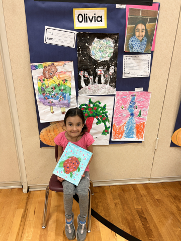 A student in front of their artwork.