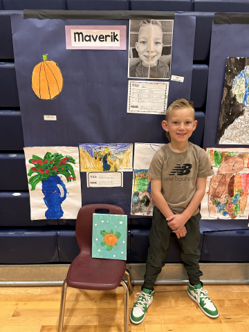 A student in front of their artwork.