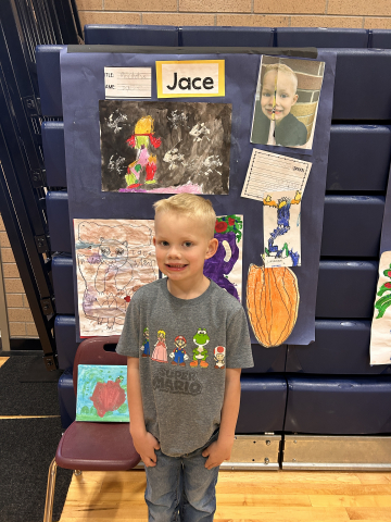 A student in front of their artwork.