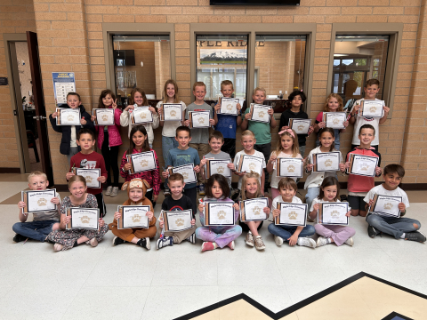 Students holding their certificates.