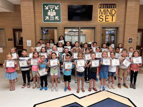 Students holding their certificates.