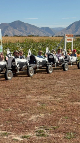 Students riding on the train ride at the pumpkin patch.